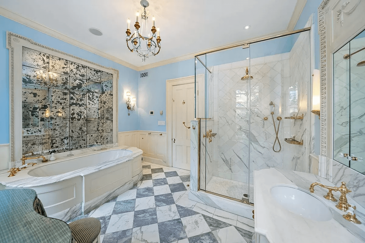 bathroom with soaking tub, glass shower and marble vanity