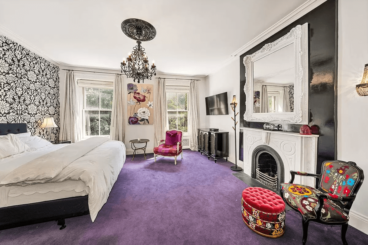 bedroom with a mantel and purple carpet