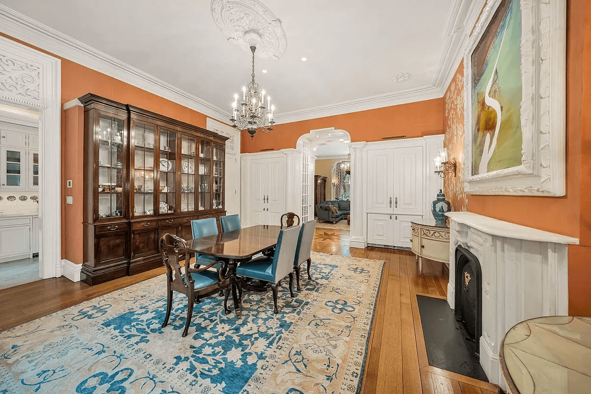 dining room with wood floors, mantel and a ceiling medallion