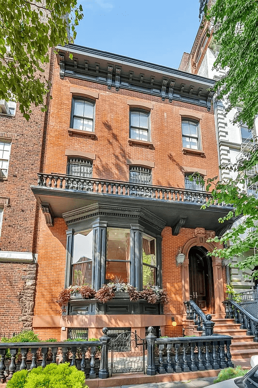 brick exterior of the house with balcony on second floor