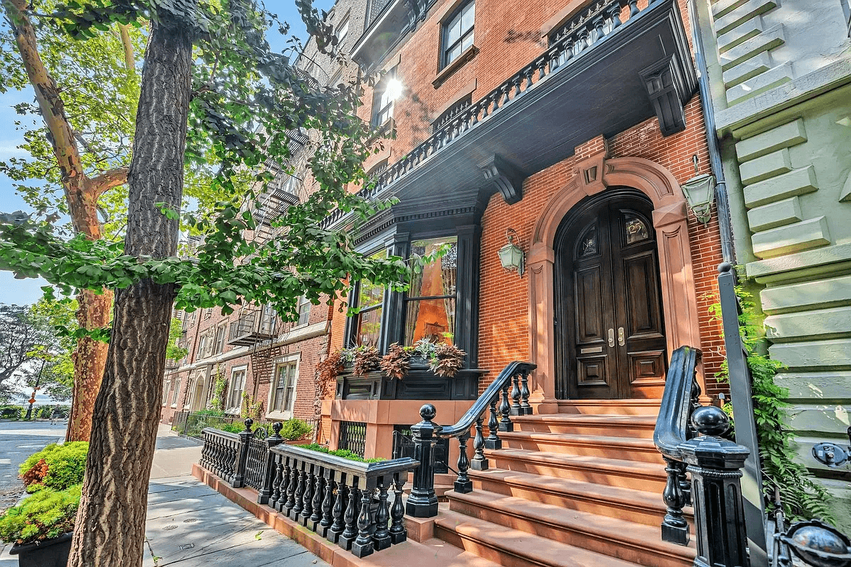 front stoop with iron railing and newel posts