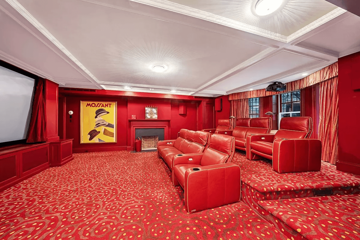 home theater with red walls and carpet