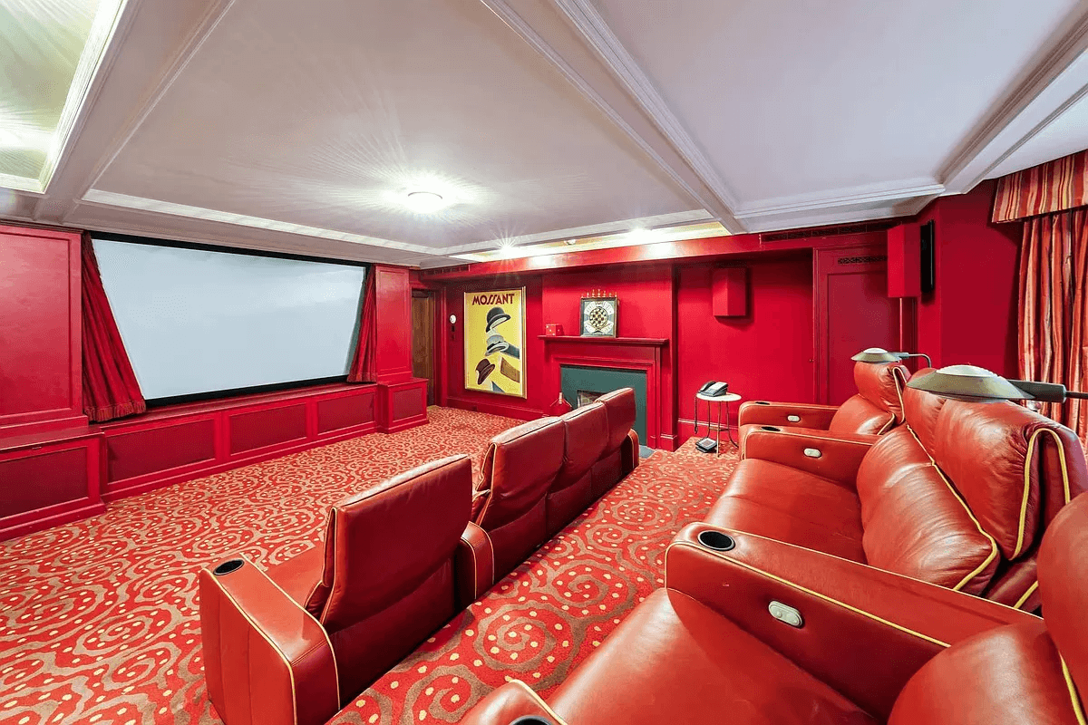 home theater with large screen, red walls and red carpet