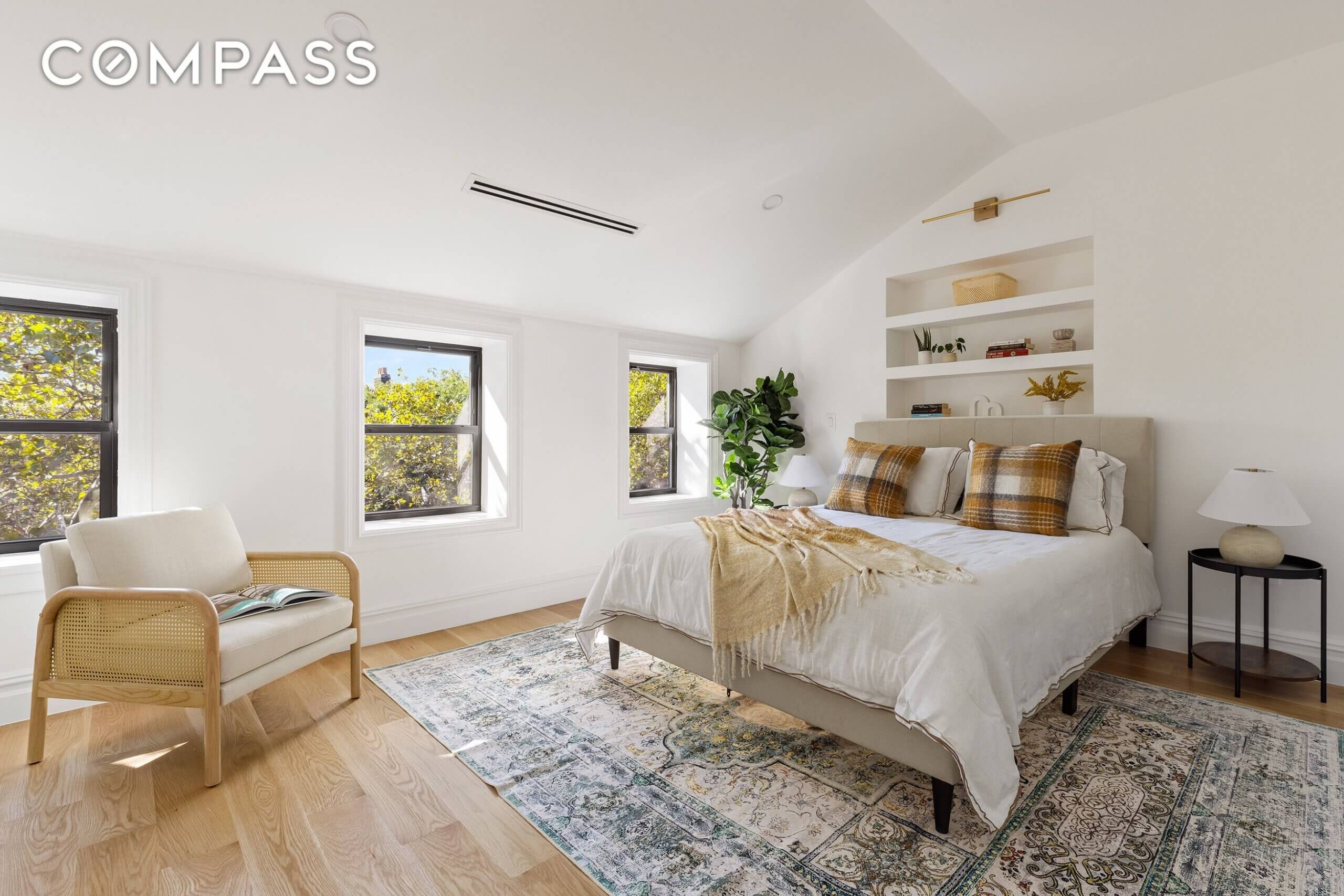 bedroom with white walls and wood floor