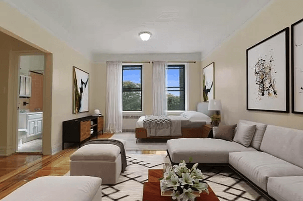 virtuall staged living area with glimpse of bathroom with pink tile