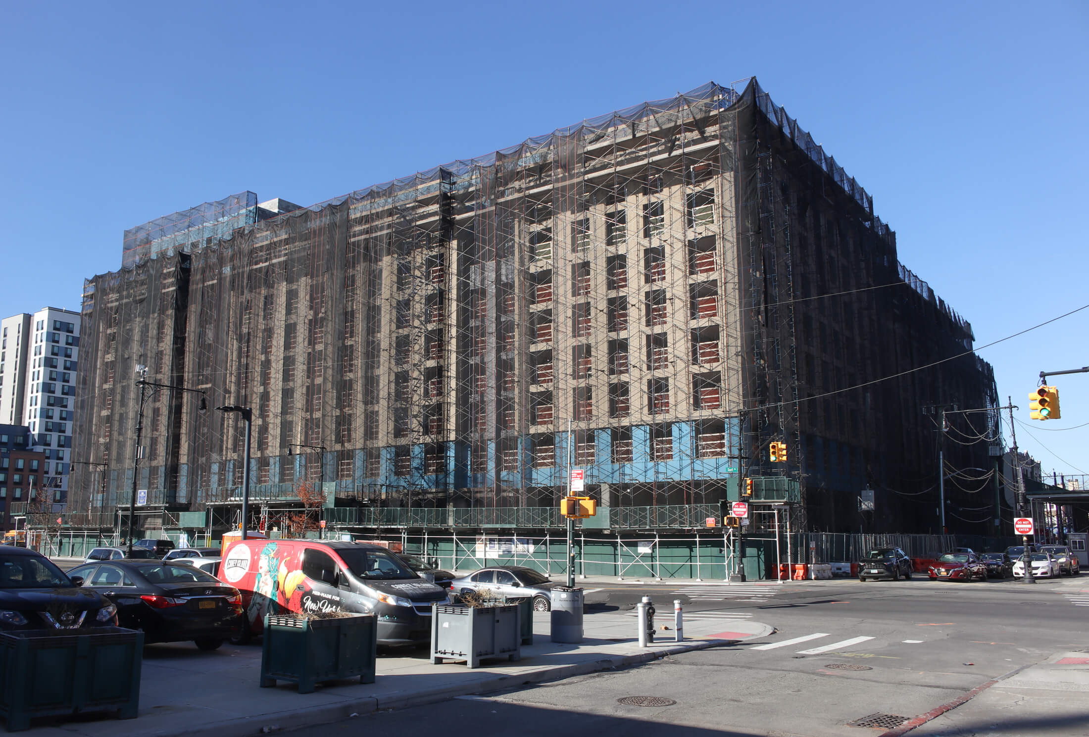 affordable housing lottery opens for the building pictured under scaffolding and netting