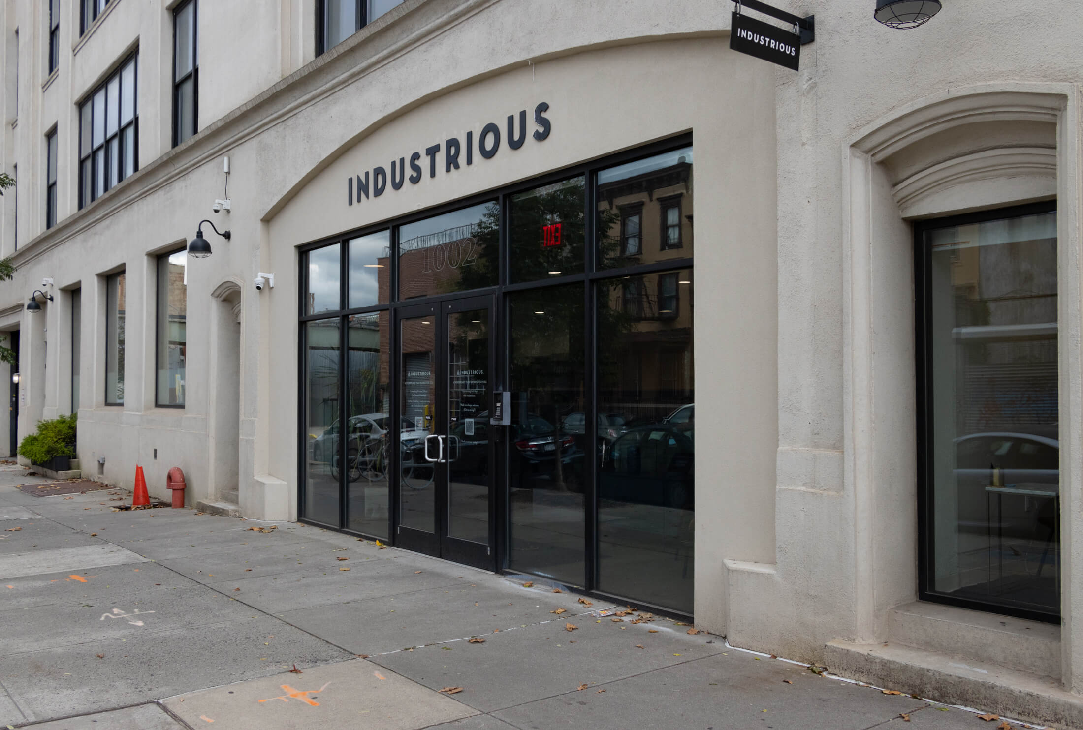 one of the entrances to the building with an Industrious sign