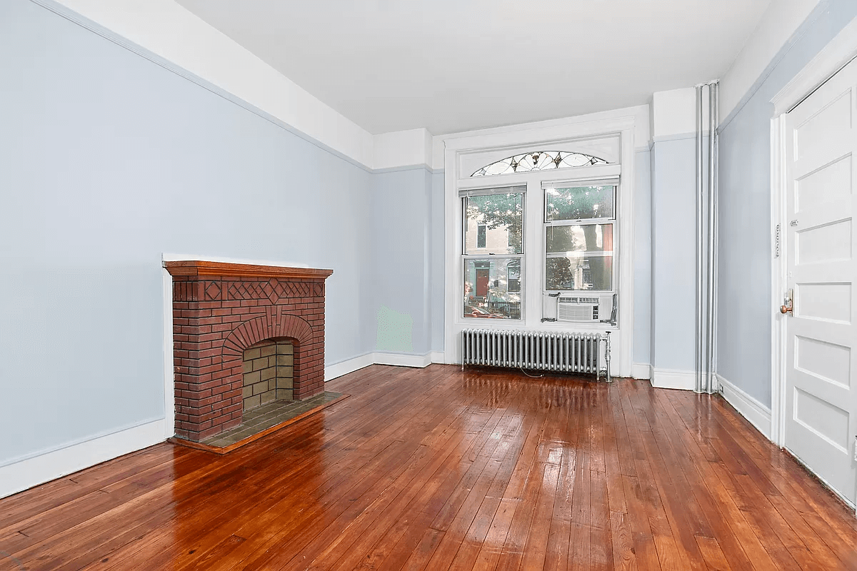 brooklyn rental - living room with a brick mantel