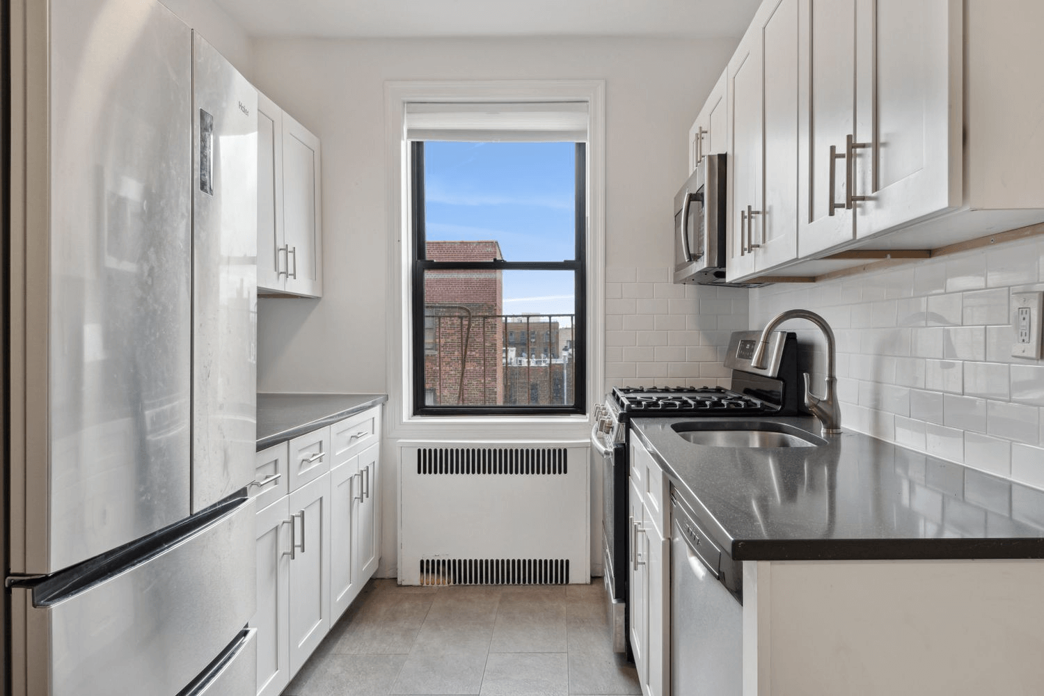 kitchen with white cabinets and subway tile