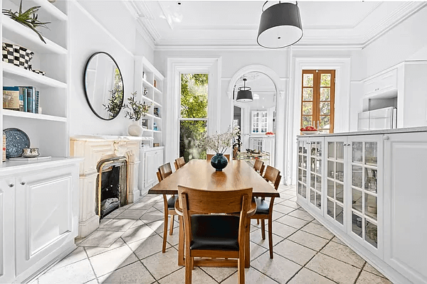 dining area and kitchen with built-ins and a mantel