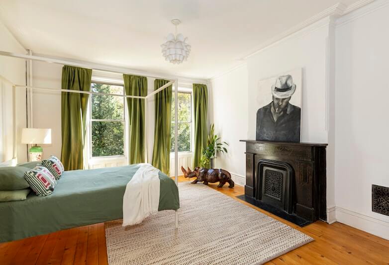 bedroom wood floor and two windows