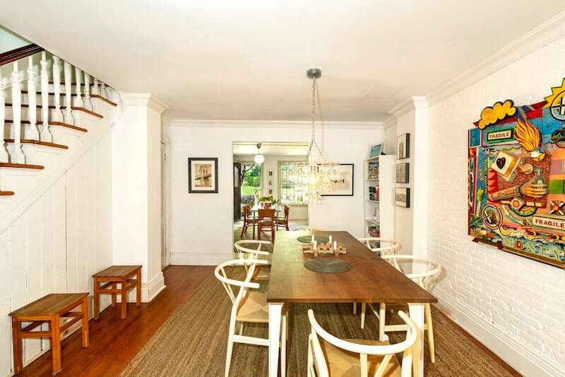 dining area on garden level with white painted exposed brick wall