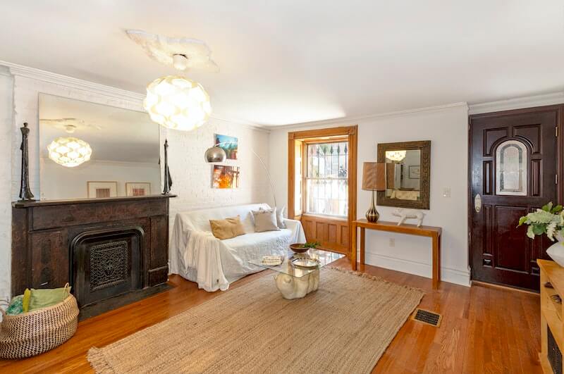 garden level living room with mantel and wood floor