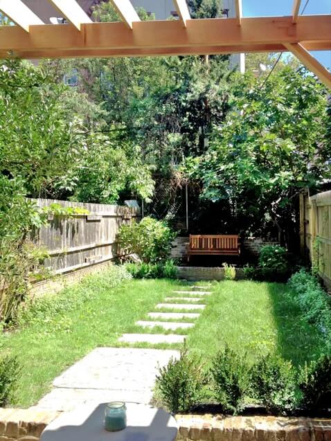 rear garden with a lawn and paving stones