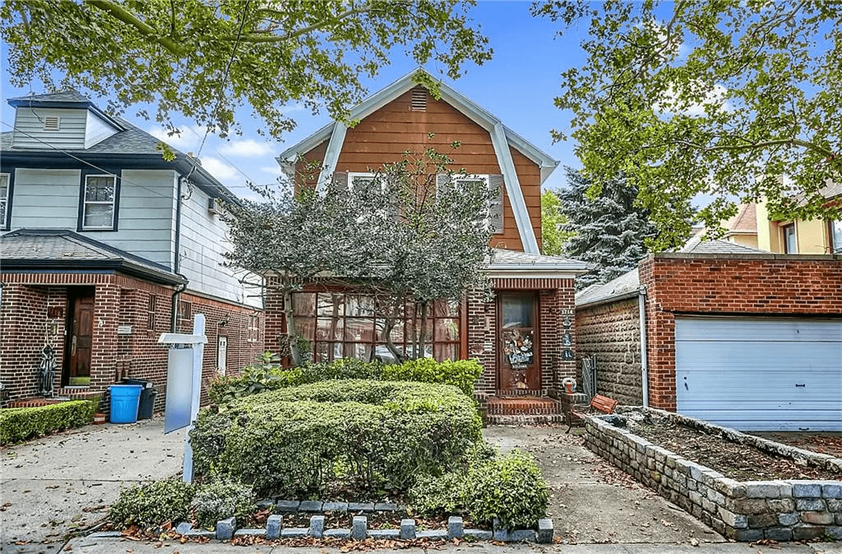 1920s dutch colonial style standalone house with a brick porch