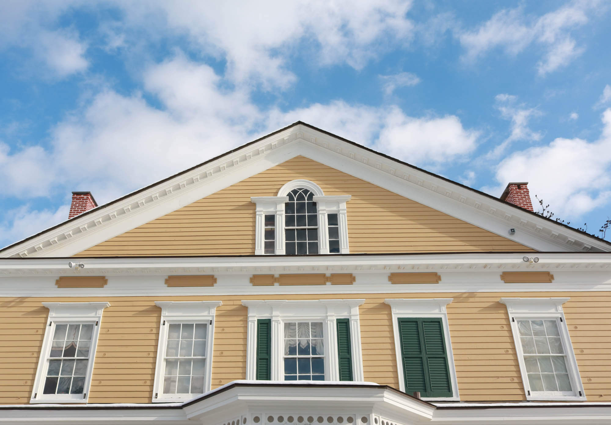 newburgh - roofline of the yellow with white trim house