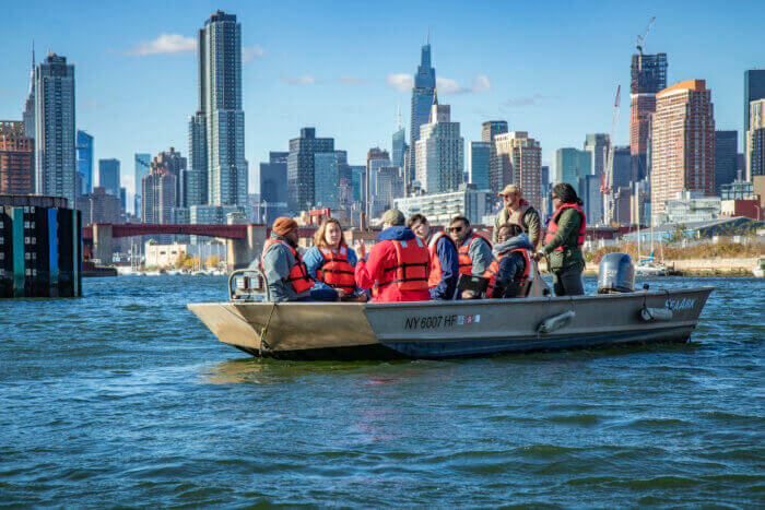 people in life jackets on a boat