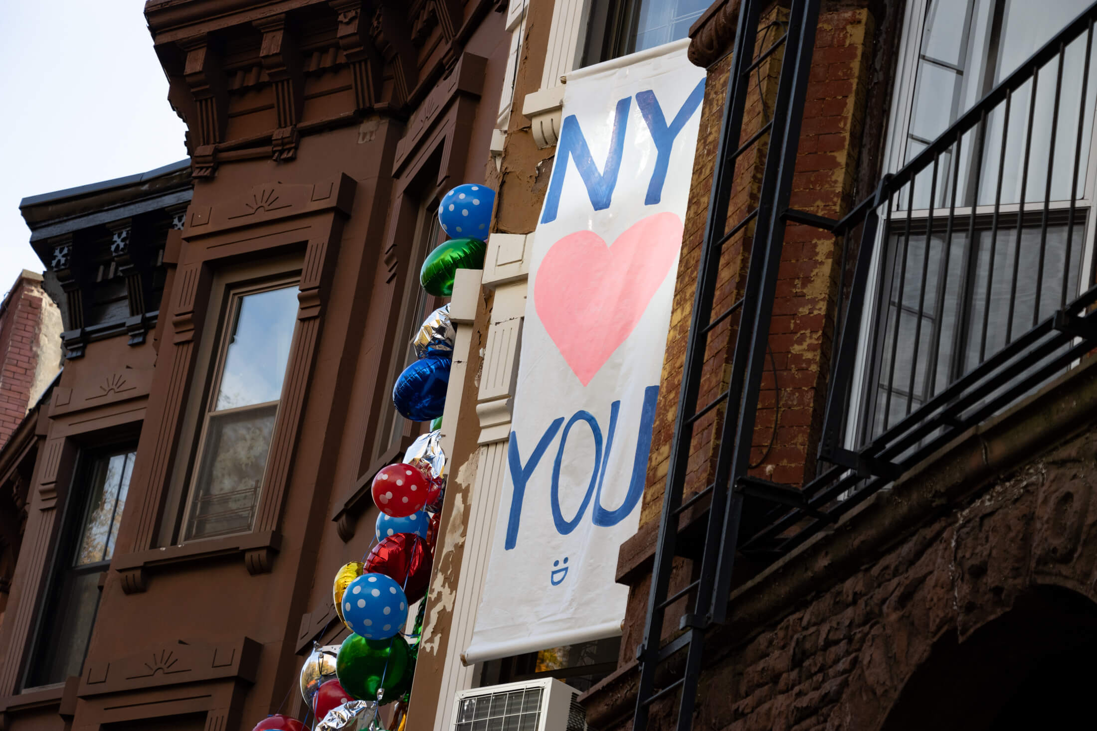 brownstone with balloons and signs