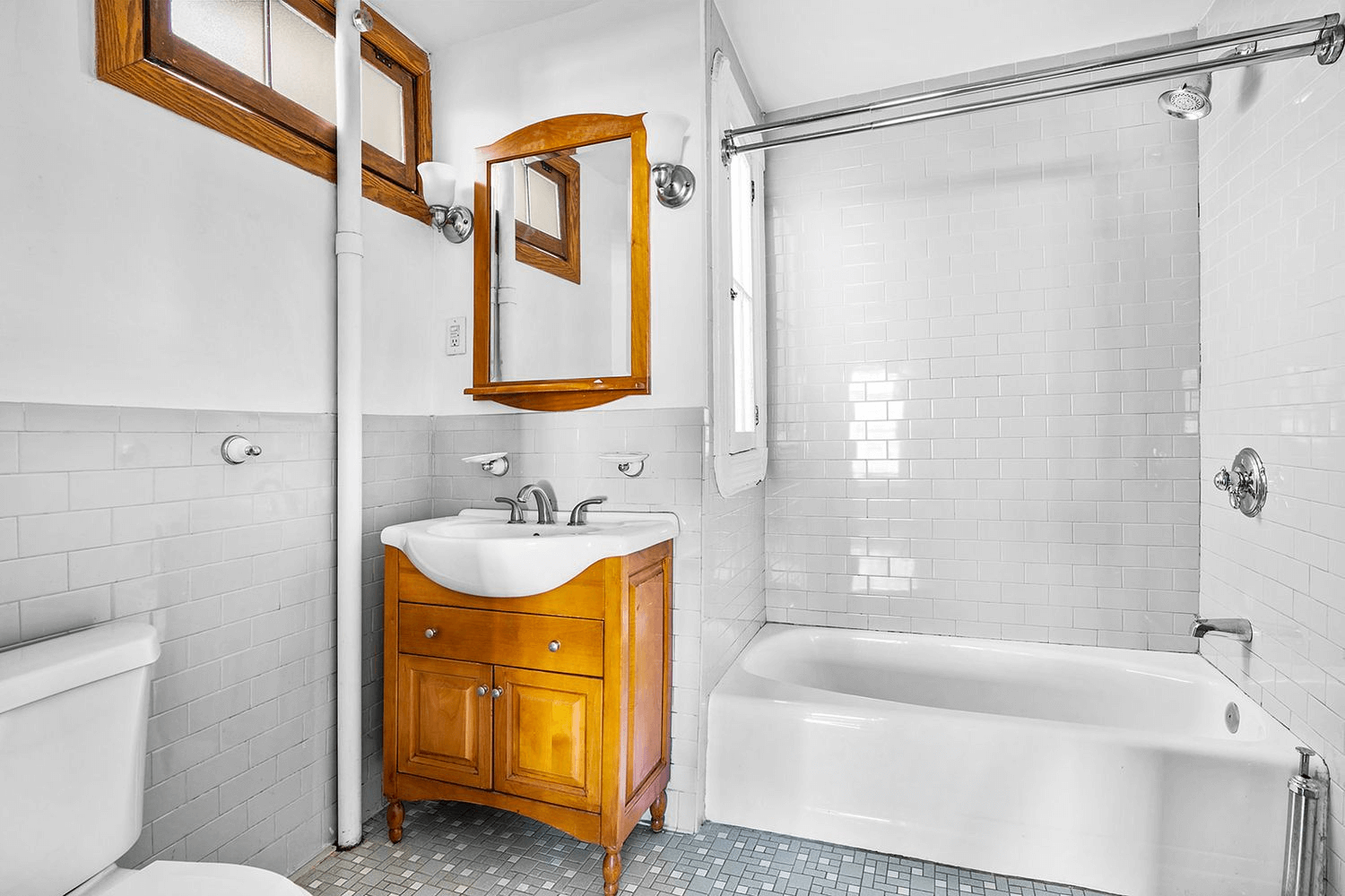 bathroom with small window and a white tub