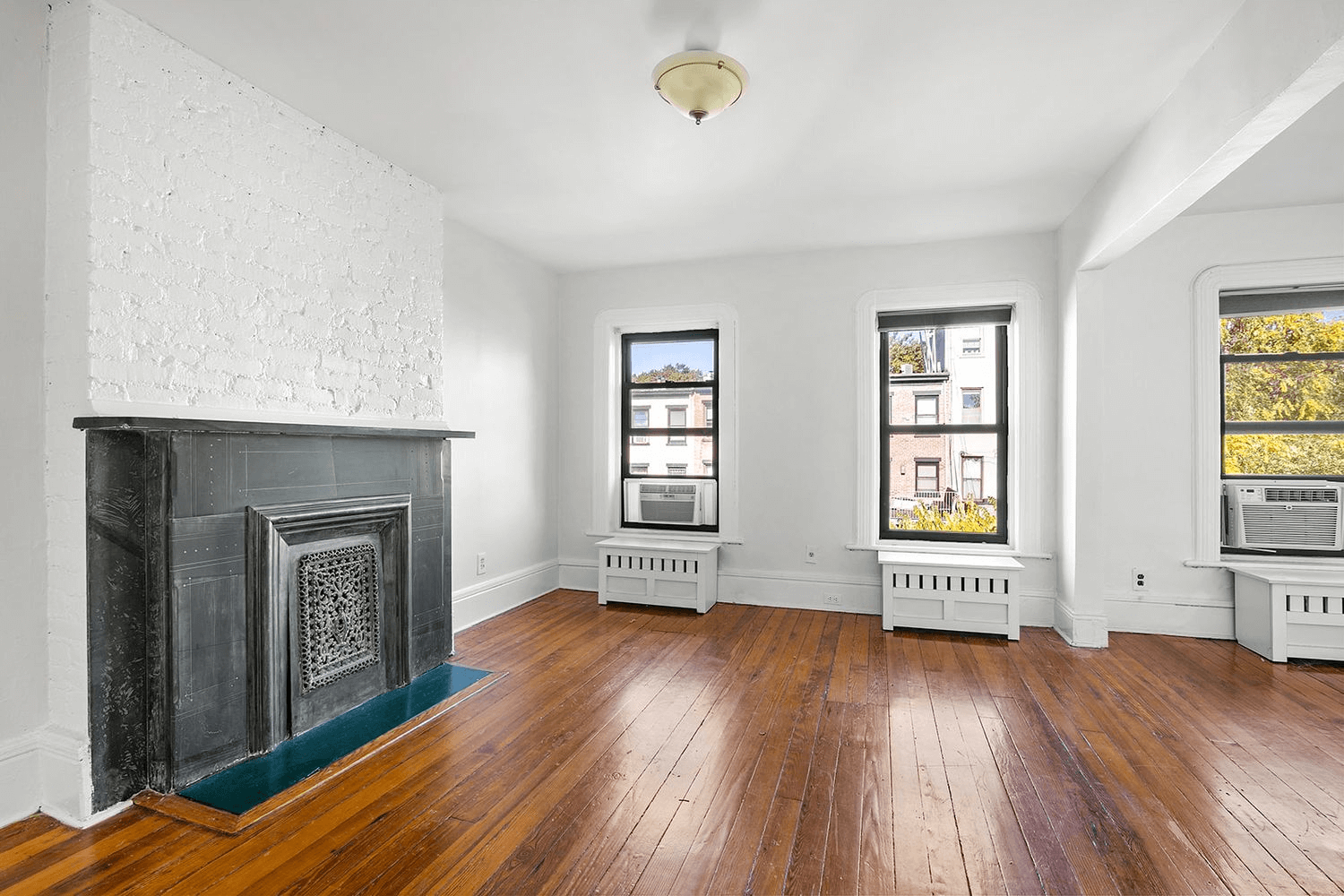 bedroom with slate mantel and three windows