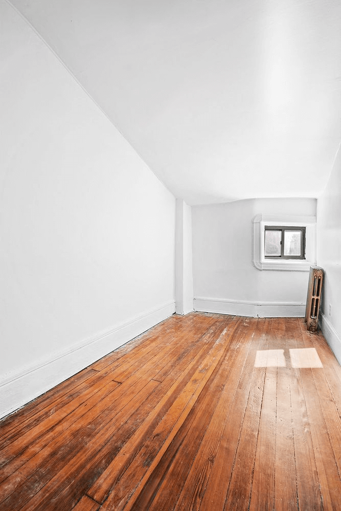 narrow bedroom with small window