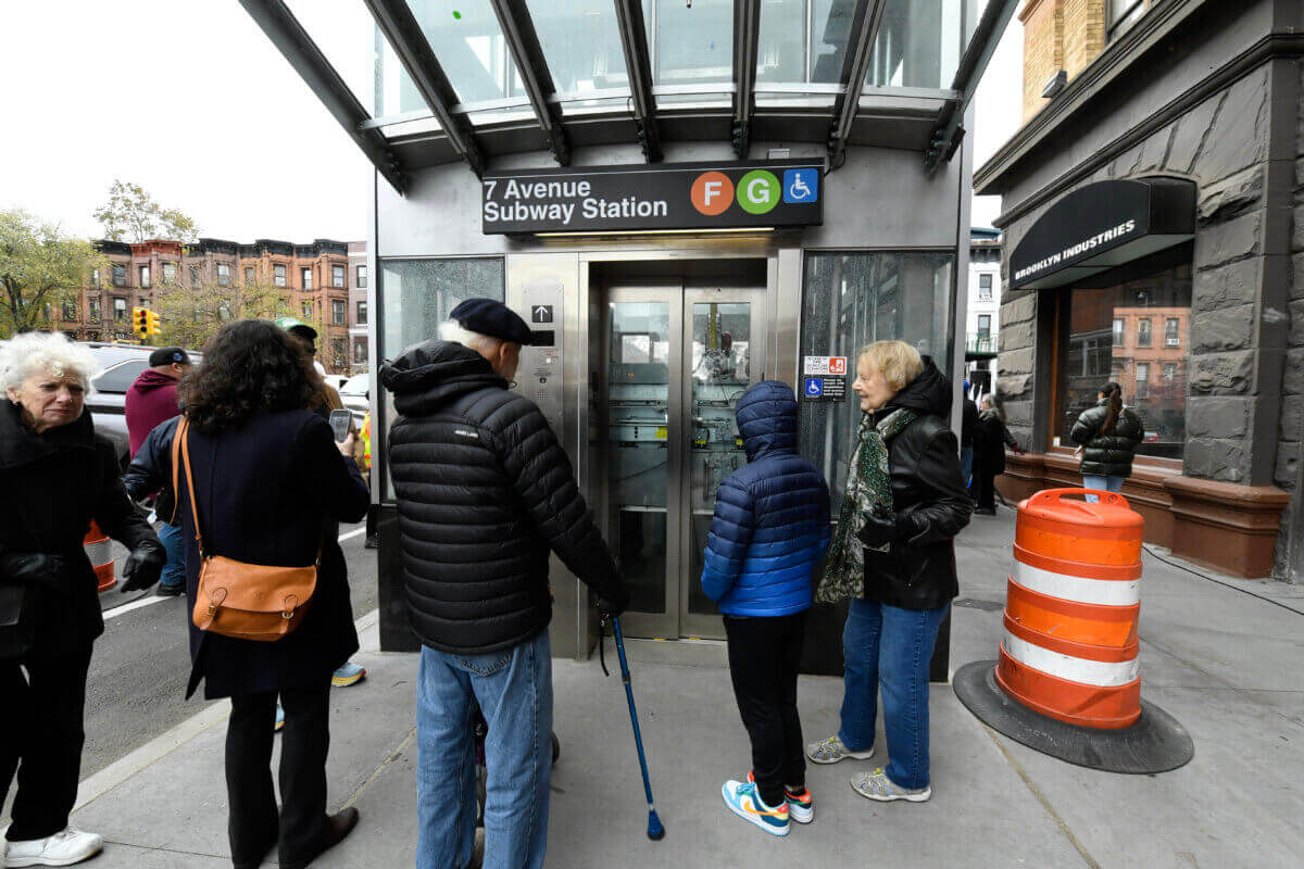 people standing outside of an elevator