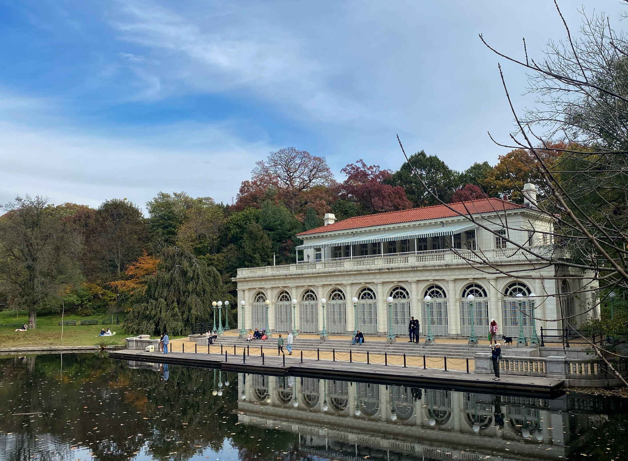 brooklyn - the boat house in prospect park with fall trees reflected in the water