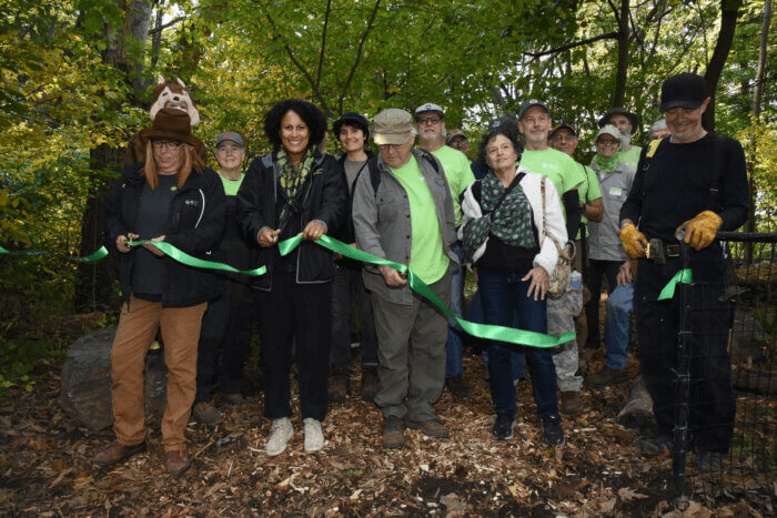 prospect park - group of people cut a ribbon on the trail
