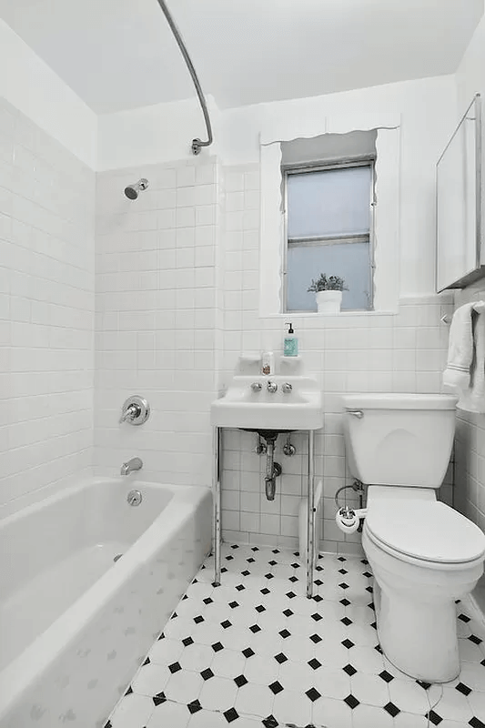 bathroom with white fixtures and white walls