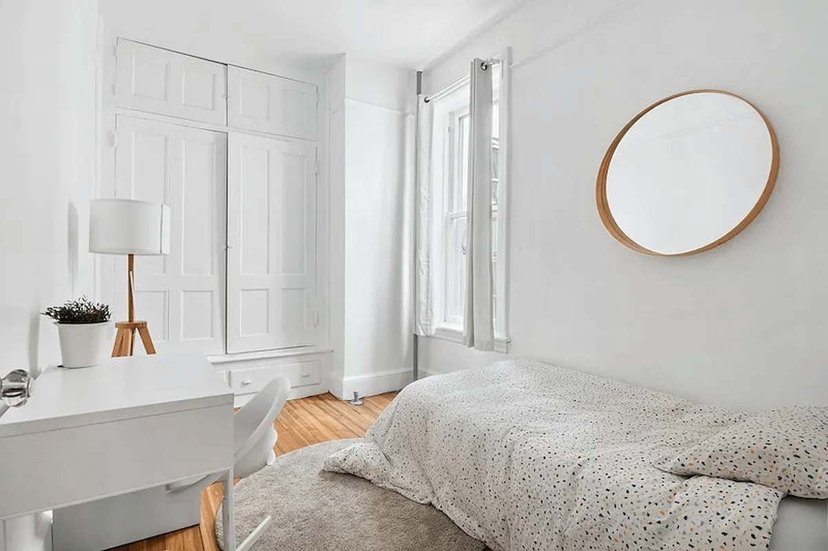 bedroom with built-in storage and white walls