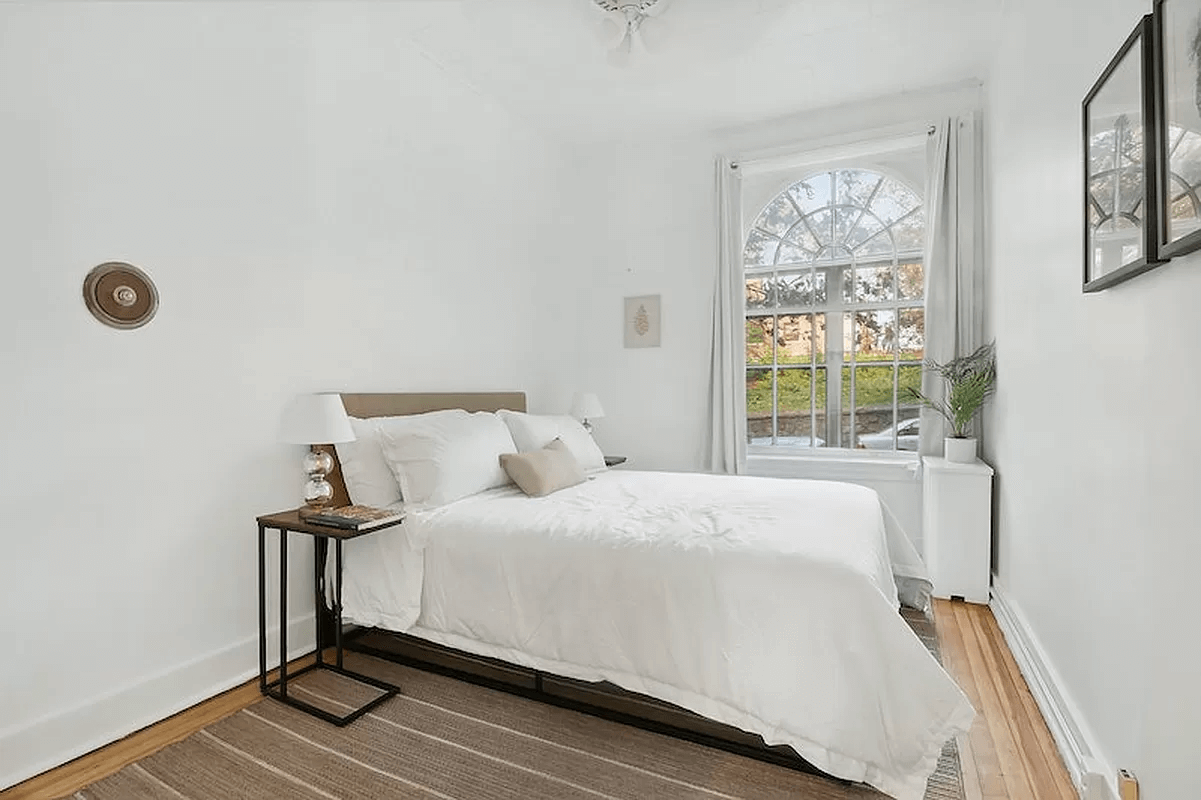 bedroom with wood floor and white walls