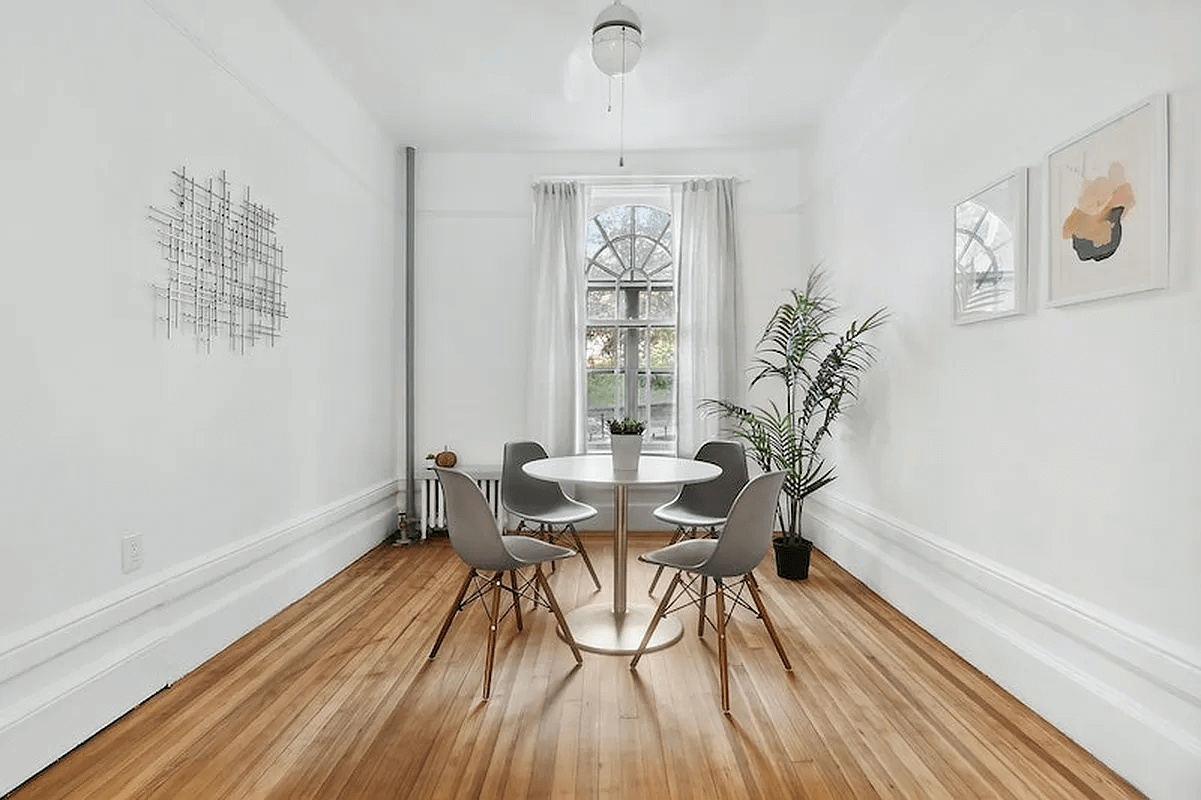 dining area with wood floor, picture rails and white walls
