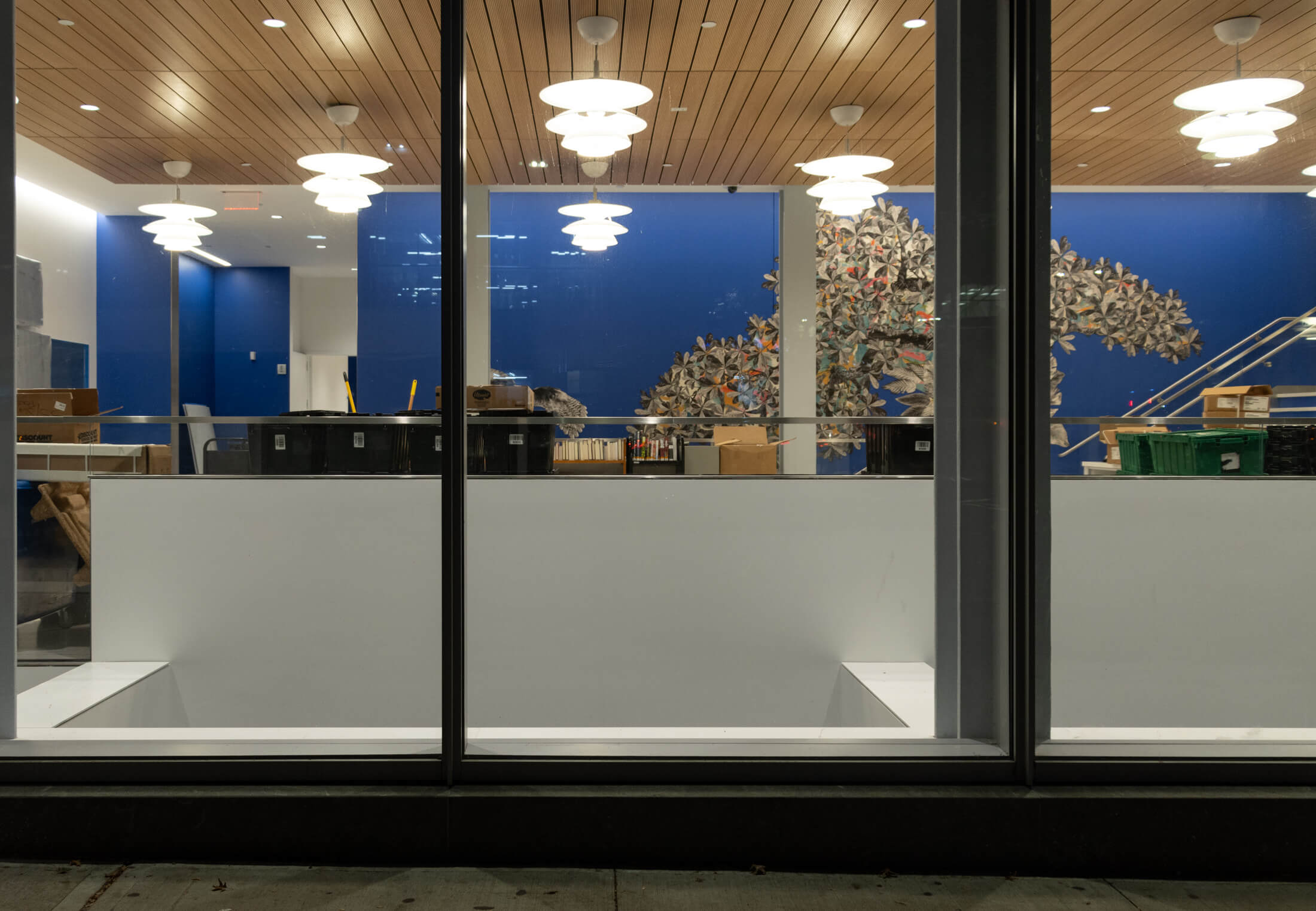 a look through the first floor windows shows artwork and a blue wall