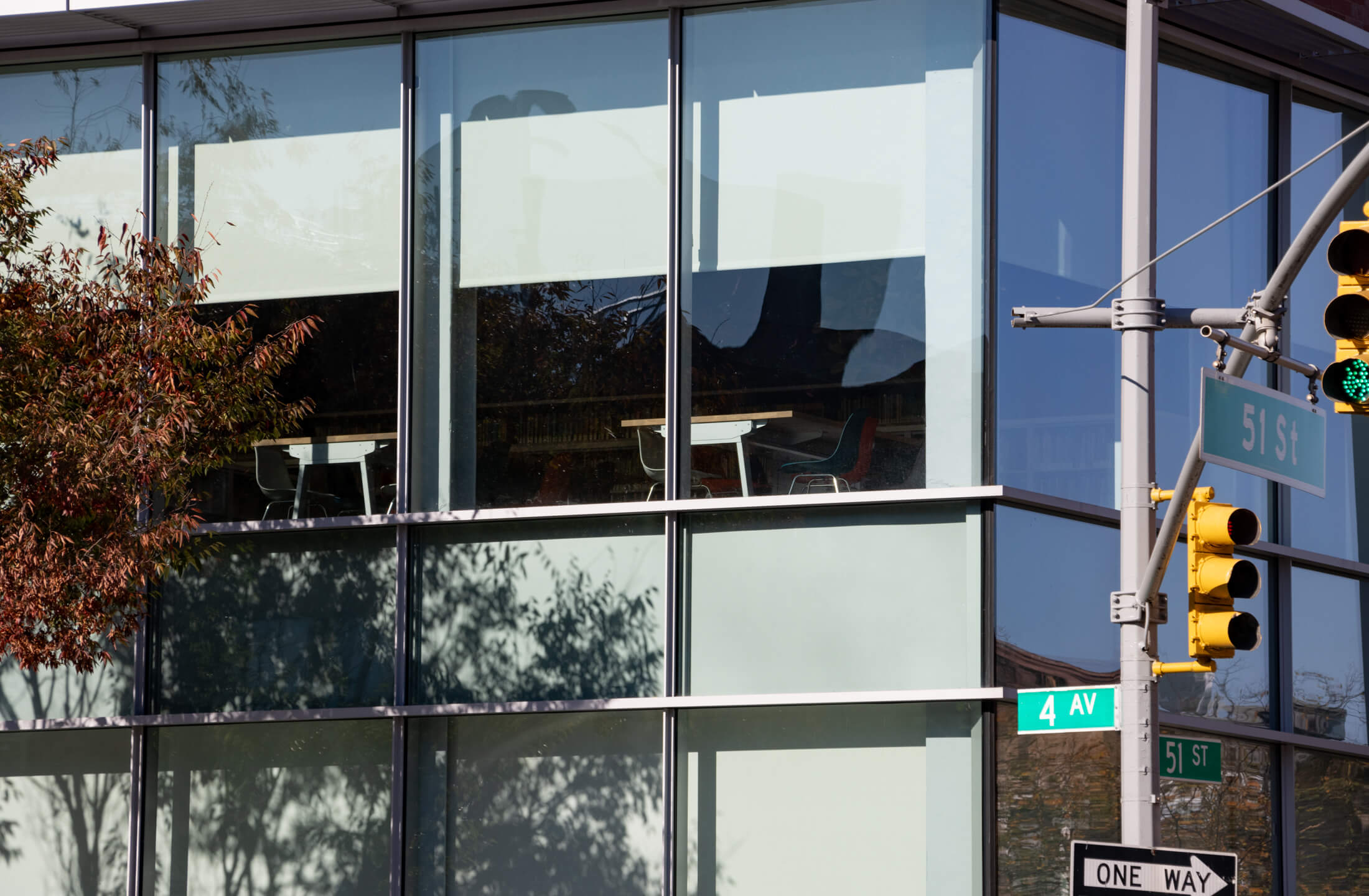 a detail of the second floor showing window shades and a hint of a tables and chairs