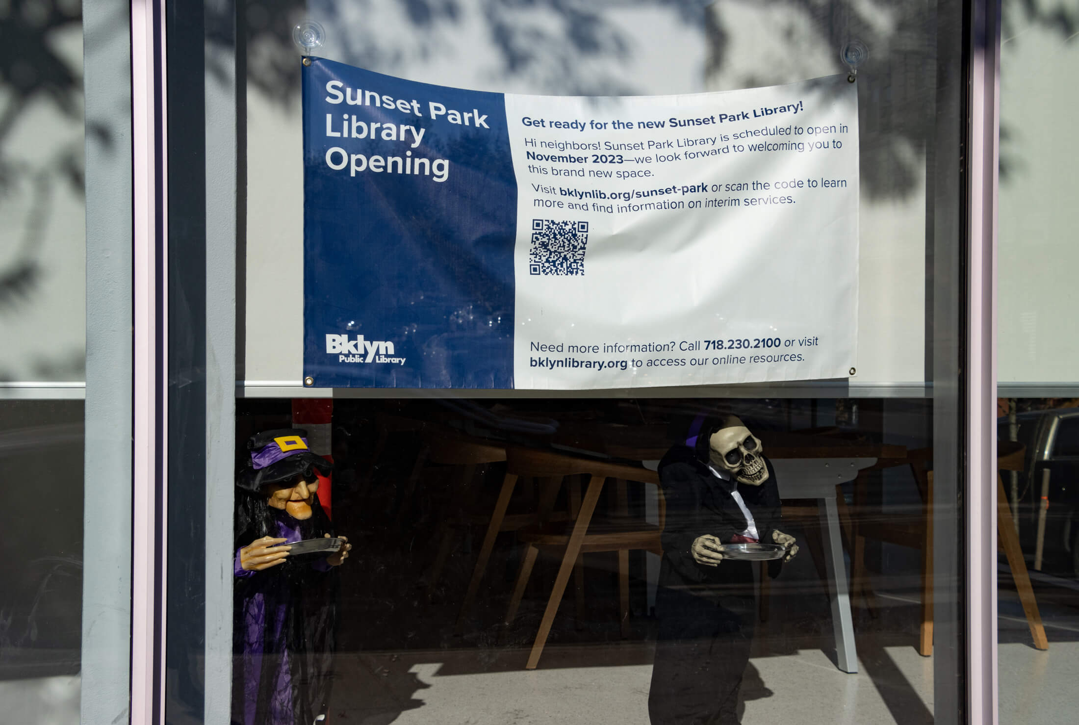 a banner noting that the library will be opening in november of 2023