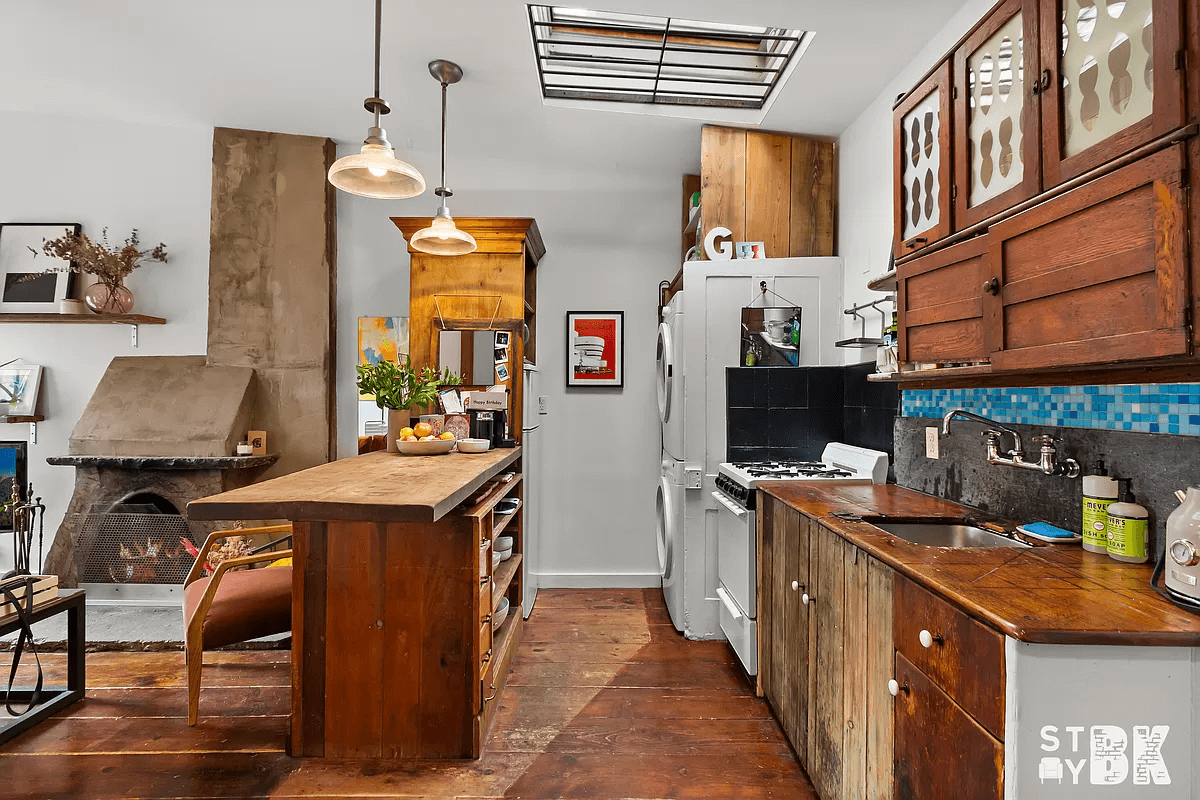kitchen with vintage wooden cabinets, wood counters and in-unit laundry