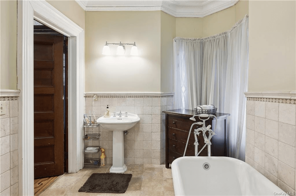 bathroom with white fixtures and beige tile