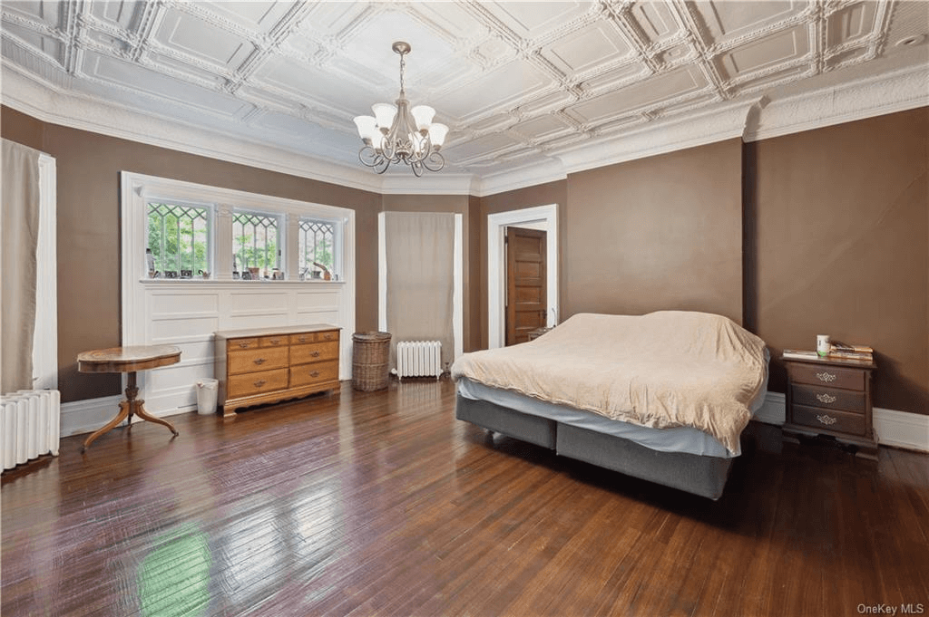 bedroom with ornamented ceiling and leaded glass windows