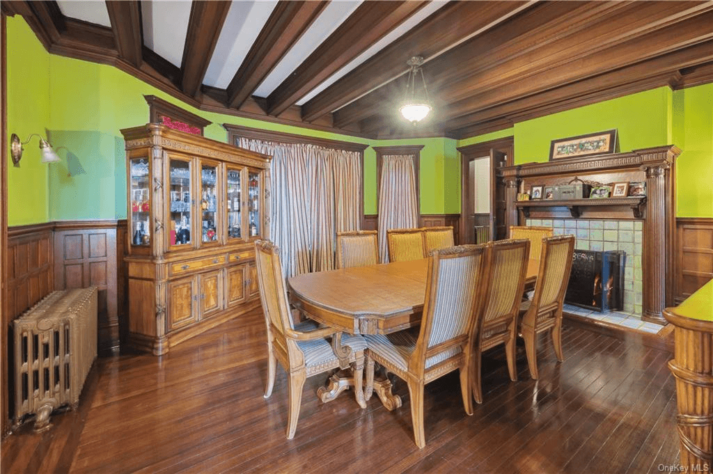 dining room with wainscoting and mantel