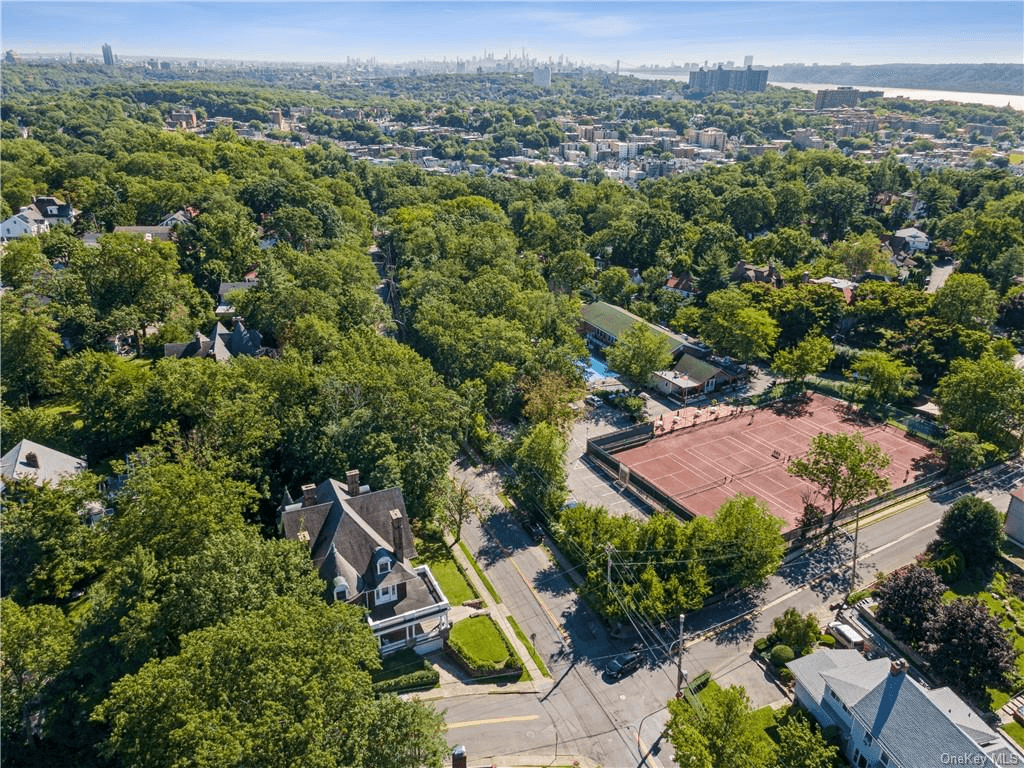 aerial showing house across the street from tennis courts