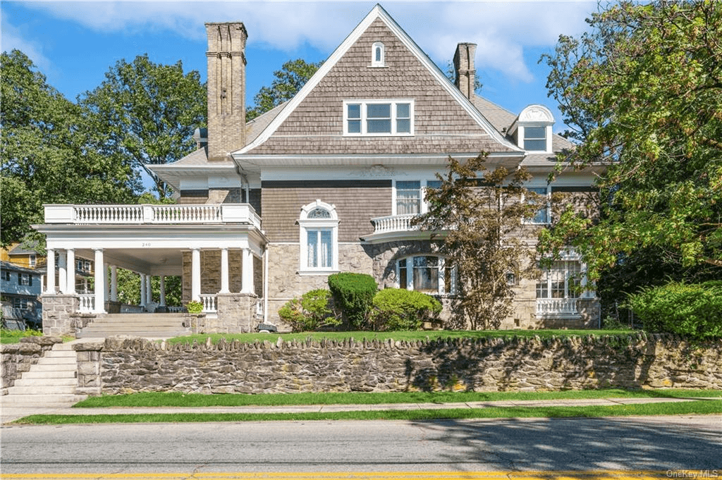 exterior of the house with stone lower level and shingled upper level