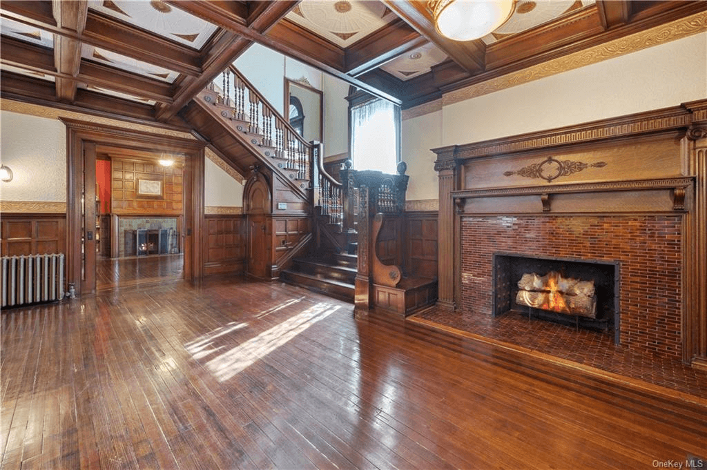 foyer with large fireplace with bench