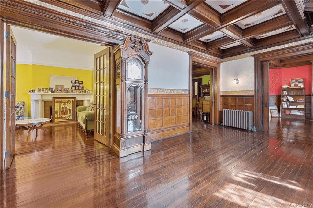 foyer with wainscoting and coffered ceiling