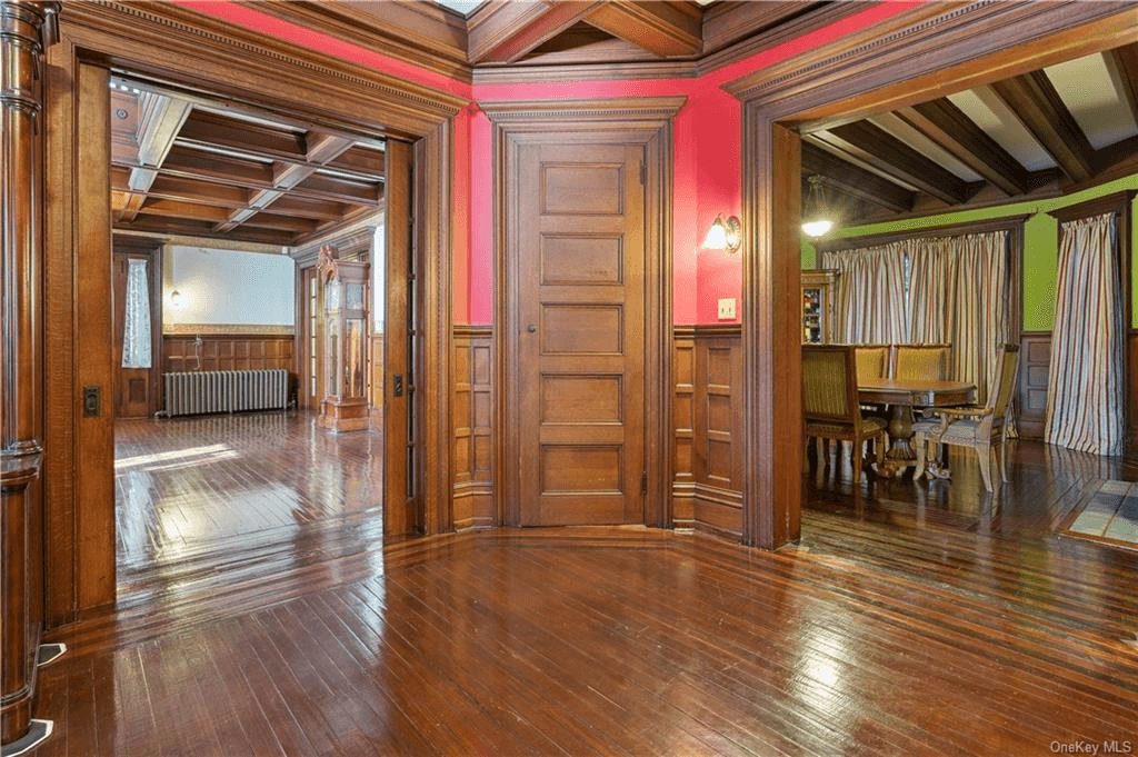 view of a corner of the office/library with a corner closet and wood floor