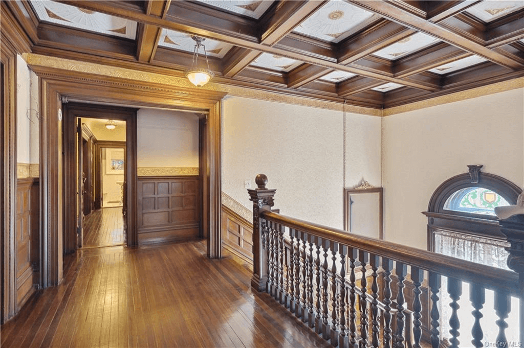 upstairs hall with coffered ceiling stained glass and original stair