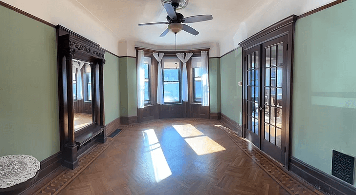 parlor with wood floor and mirror