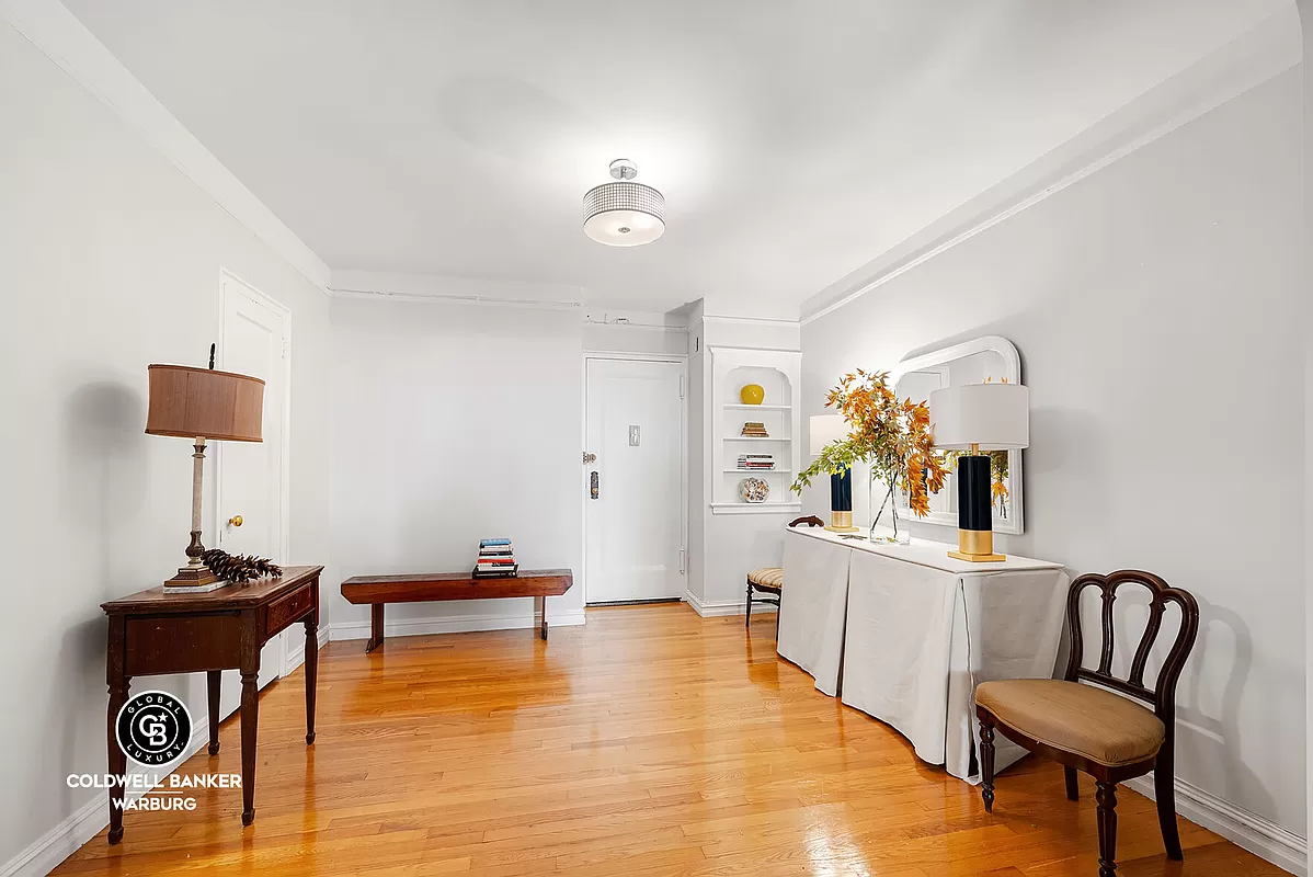 foyer with niche, picture rail and wood floor