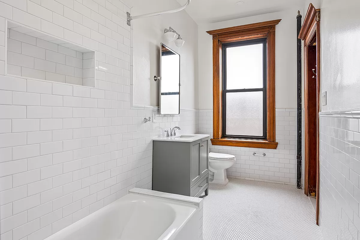 bathroom with white subway tile and fixtures
