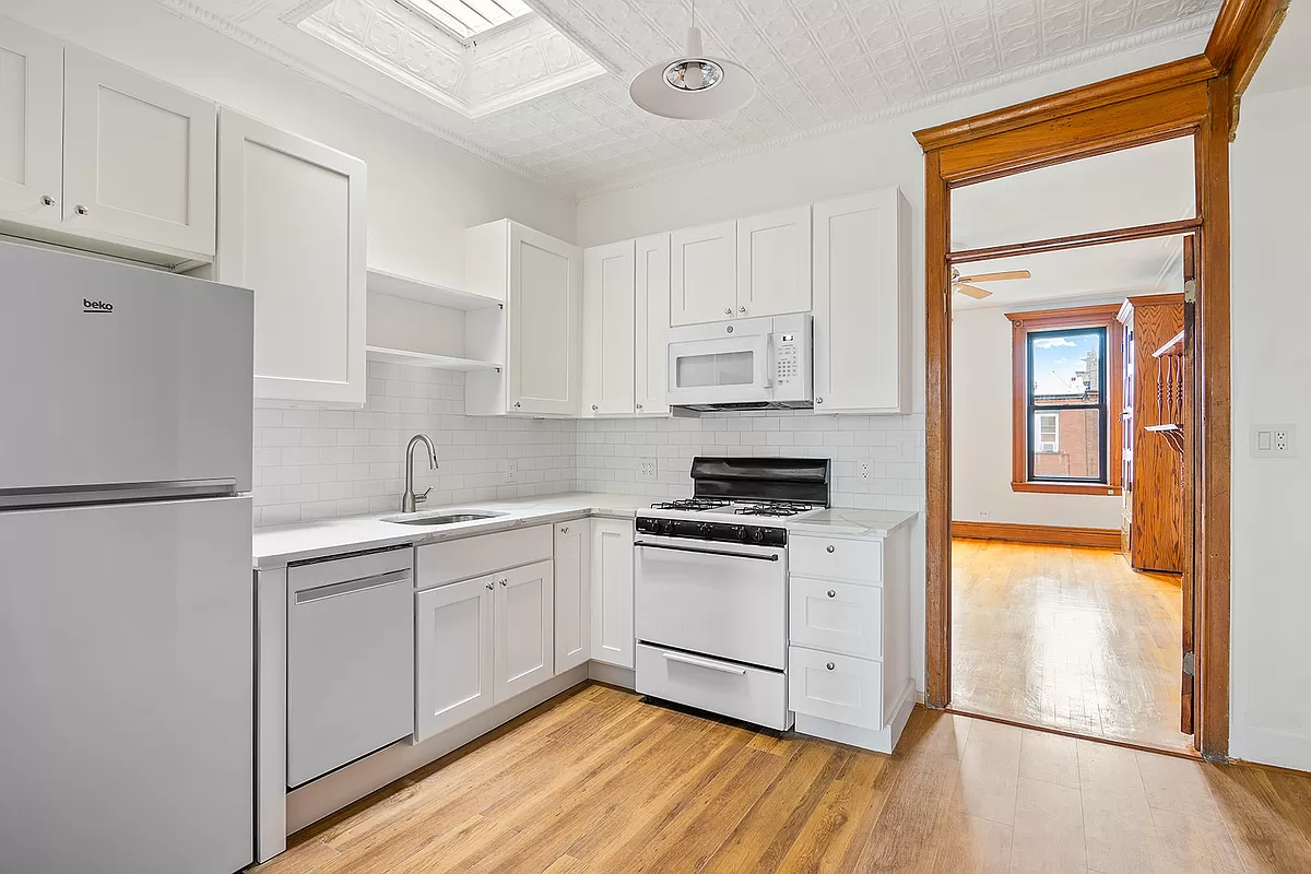 kitchen with skylight and white cabinets