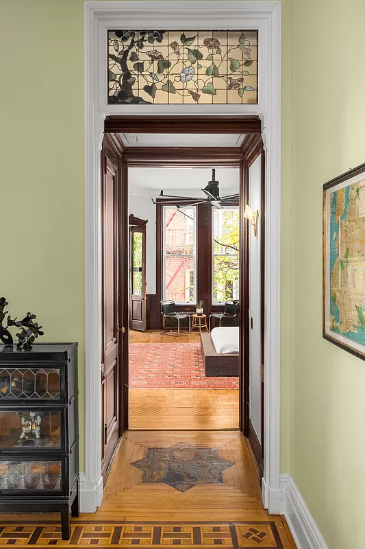 view into bedroom with stained glass transom